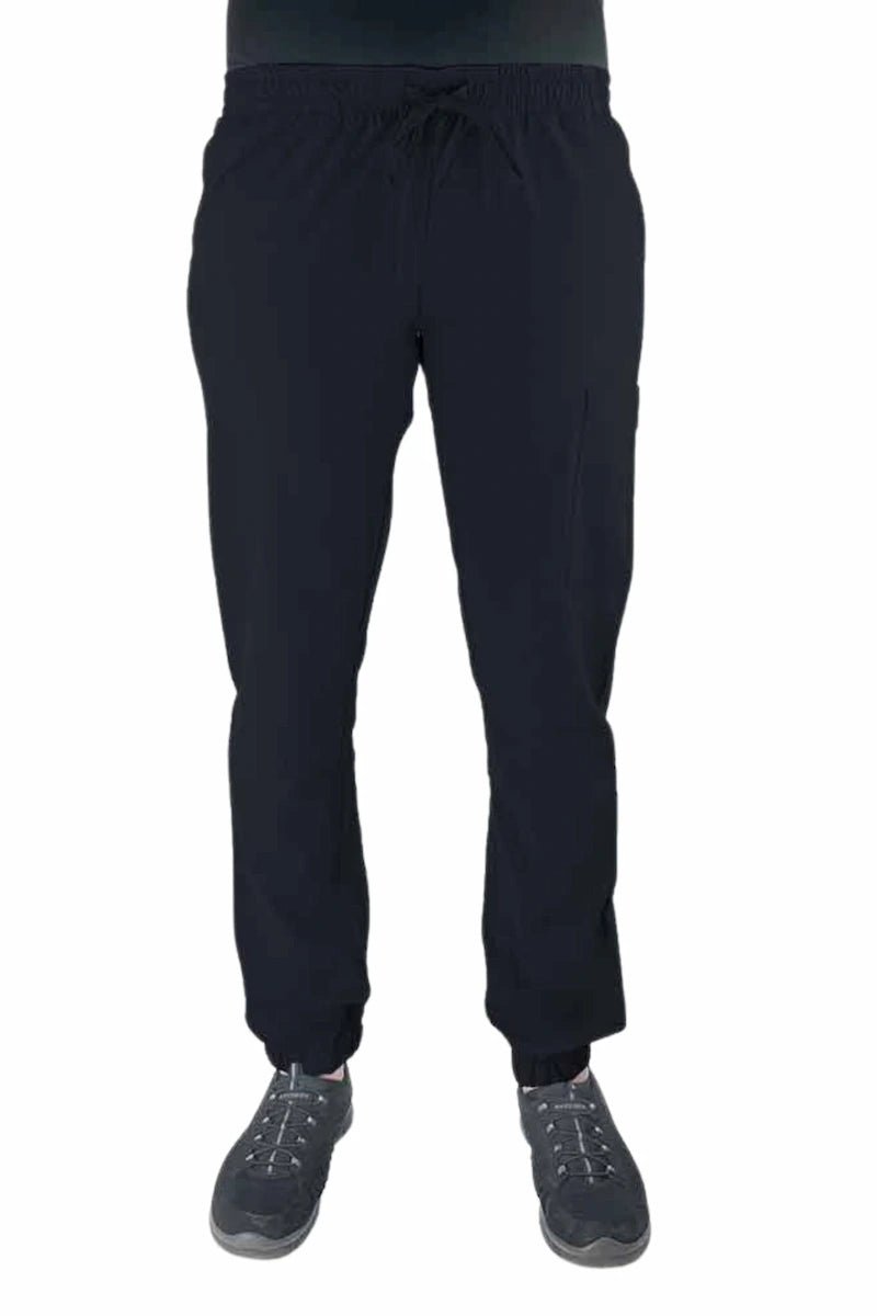 Young female healthcare worker wearing a Luv Scrubs by MedWorks Women's Scrub Jogger in black with 2 front slash pockets & 1 cargo pocket on wearer's left leg.