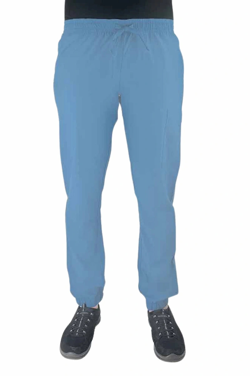 Young female healthcare worker wearing a Luv Scrubs by MedWorks Women's Scrub Jogger in ceil with 2 front slash pockets & 1 cargo pocket on wearer's left leg.