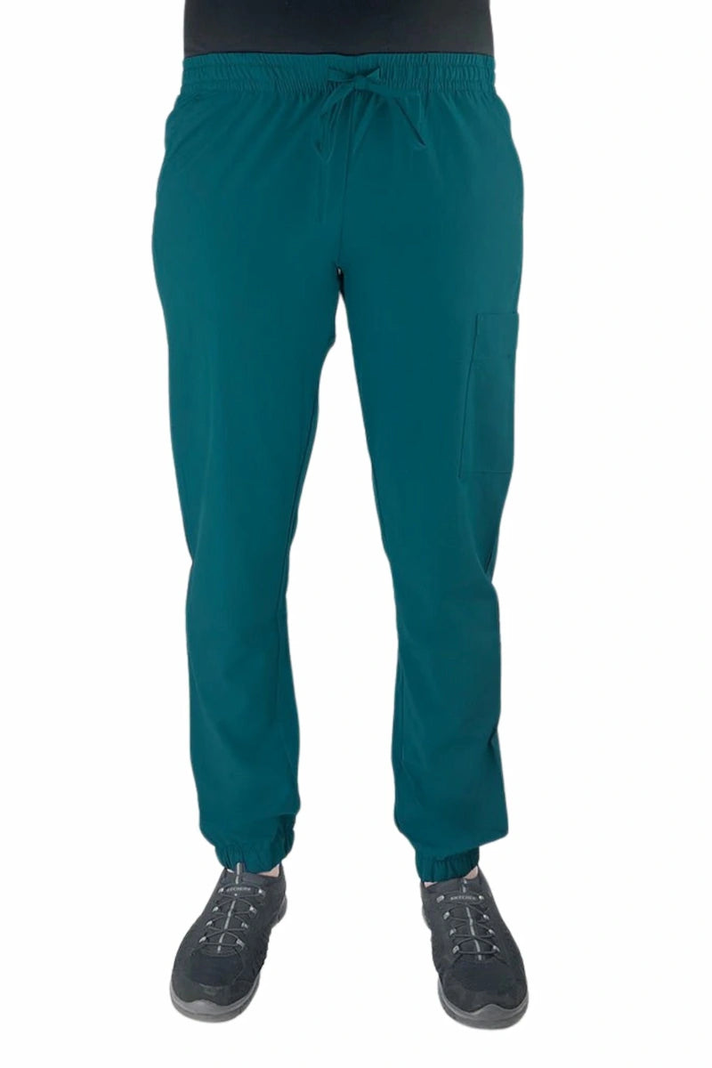 Young female healthcare worker wearing a Luv Scrubs by MedWorks Women's Scrub Jogger in Caribbean with 2 front slash pockets & 1 cargo pocket on wearer's left leg.