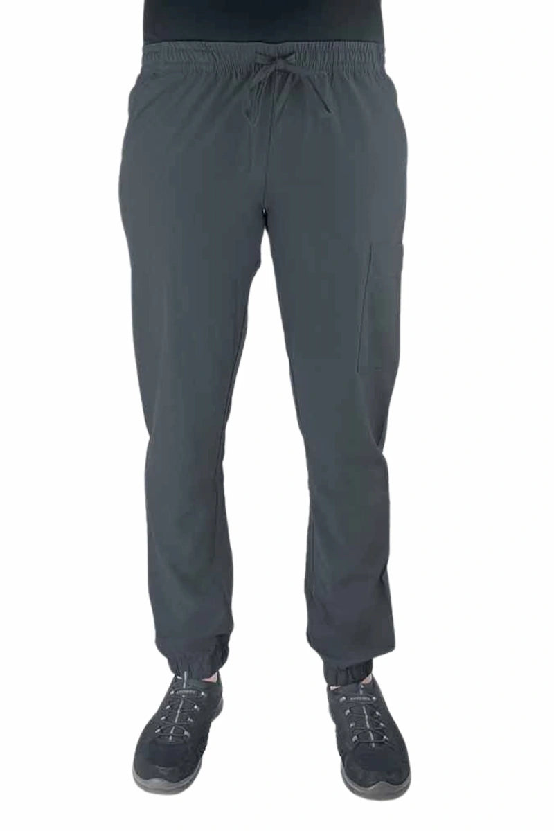 Young female healthcare worker wearing a Luv Scrubs by MedWorks Women's Scrub Jogger in pewter with 2 front slash pockets & 1 cargo pocket on wearer's left leg.