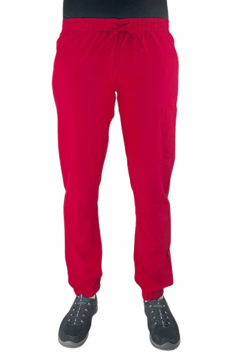 Young female healthcare worker wearing a Luv Scrubs by MedWorks Women's Scrub Jogger in red with 2 front slash pockets & 1 cargo pocket on wearer's left leg.