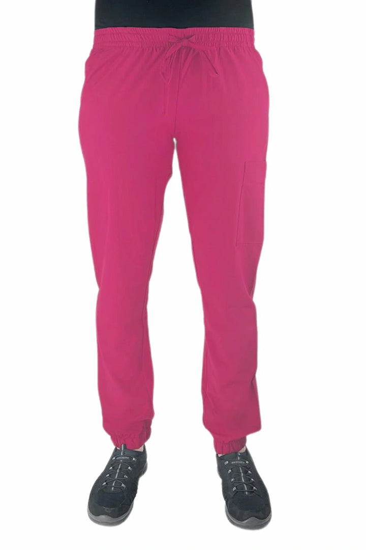 Young female healthcare worker wearing a Luv Scrubs by MedWorks Women's Scrub Jogger in shocking pink with 2 front slash pockets & 1 cargo pocket on wearer's left leg.