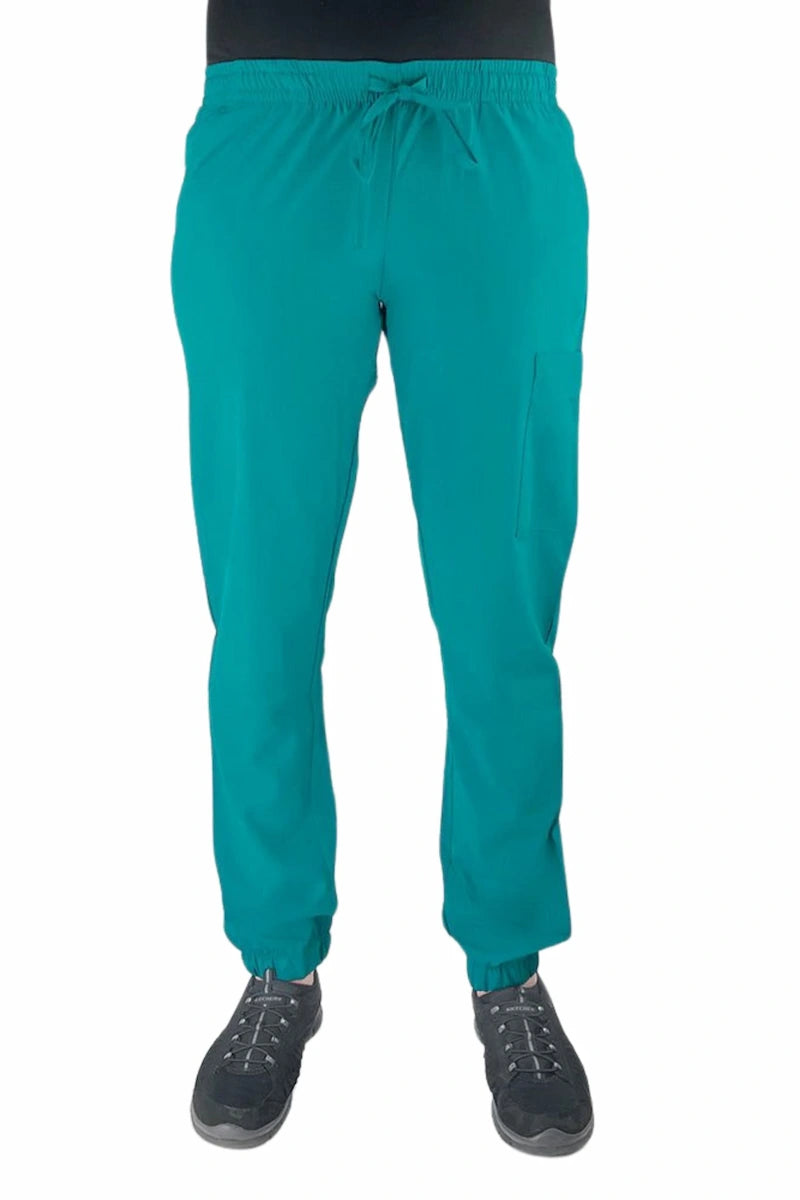 Young female healthcare worker wearing a Luv Scrubs by MedWorks Women's Scrub Jogger in teal with 2 front slash pockets & 1 cargo pocket on wearer's left leg.