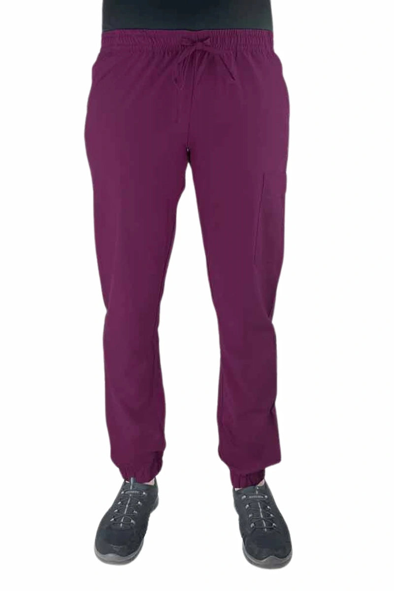 Young female healthcare worker wearing a Luv Scrubs by MedWorks Women's Scrub Jogger in wine with 2 front slash pockets & 1 cargo pocket on wearer's left leg.