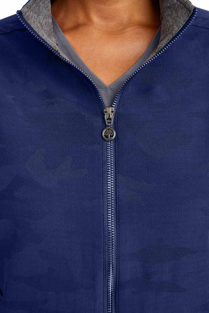 A close up view of the neckline of the Purple Label Women's Destini Camo Scrub Jacket in Navy size XS.