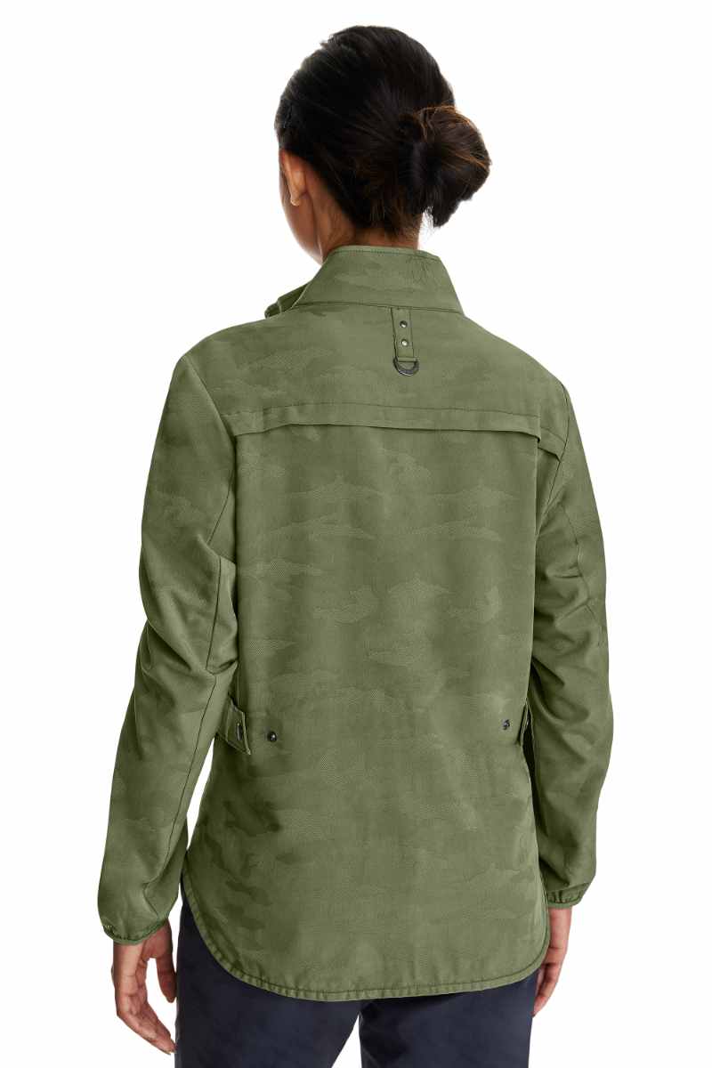 A young female Physical Therapist wearing a Purple Label Women's Destini Camo Scrub Jacket in Olive size 2XL featuring adjustable back tabs to ensure a flattering all day fit.