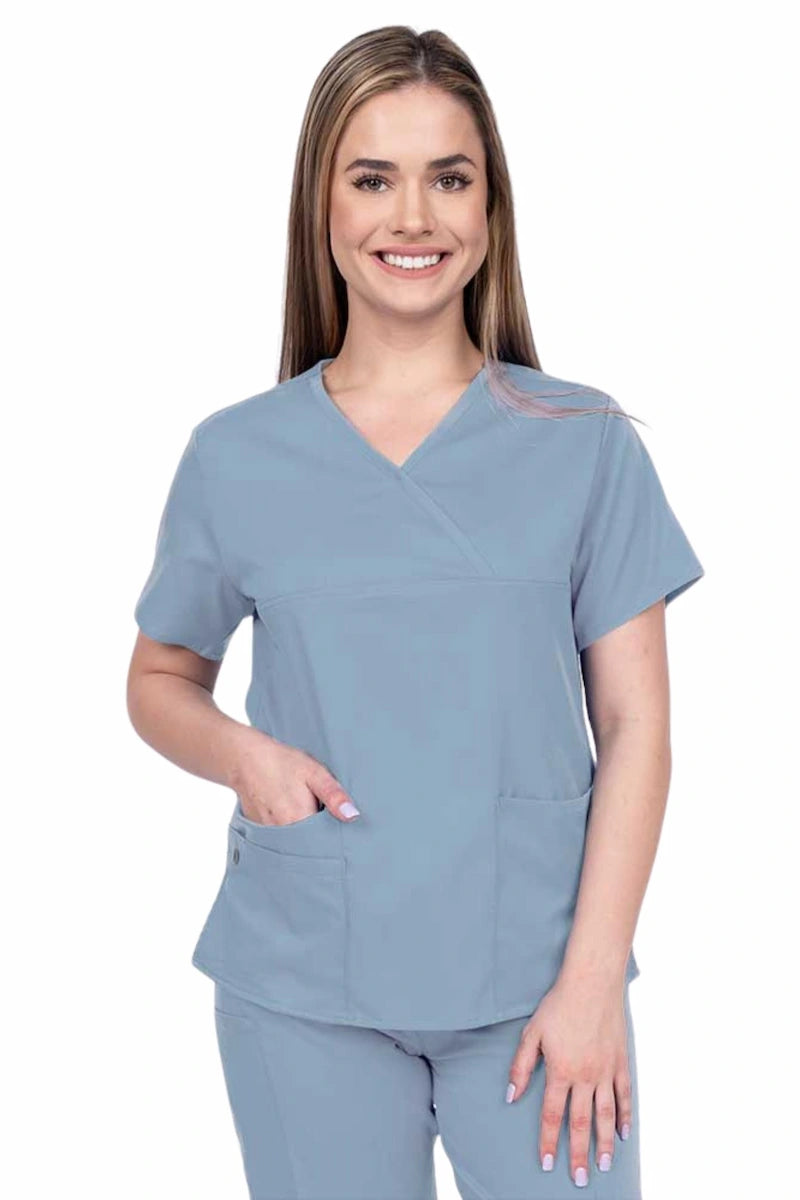 Woman wearing an Epic by MedWorks Women's Y-Neck Scrub Top in blue fog with a super soft, 2-way stretch fabric designed to move with your body all day long.