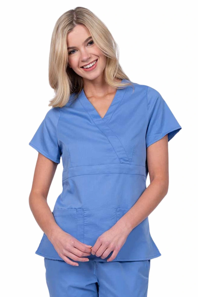 Young woman wearing an Epic by MedWorks Women's Mock Wrap Scrub Top in ceil with a unique fabric content of 77% Polyester, 21% Viscose, 2% Spandex.