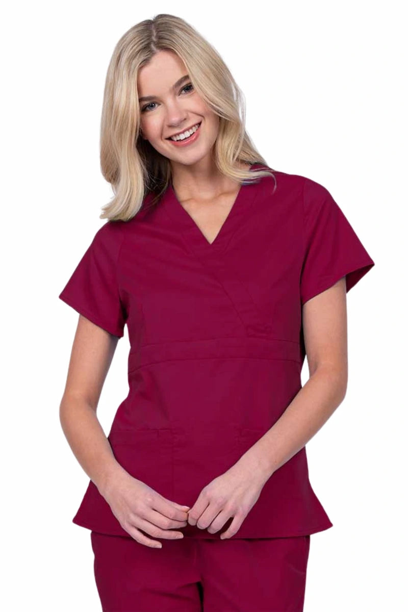 Young woman wearing an Epic by MedWorks Women's Mock Wrap Scrub Top in wine with a unique fabric content of 77% Polyester, 21% Viscose, 2% Spandex.