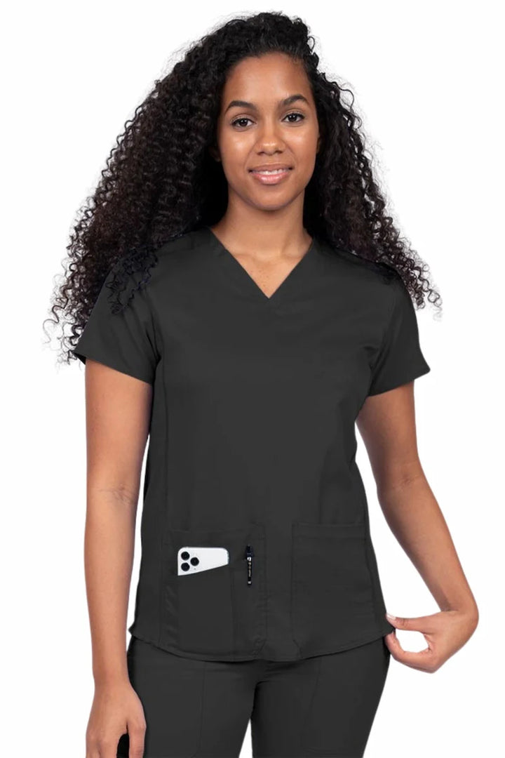 Nurse wearing an Epic by MedWorks Women's Blessed Scrub Top in black with a V-neckline & short sleeves.