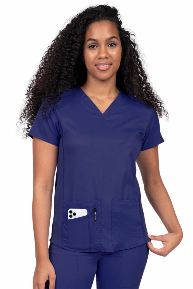 Woman wearing an Epic by MedWorks Women's Blessed Scrub Top in navy with two front patch pockets.