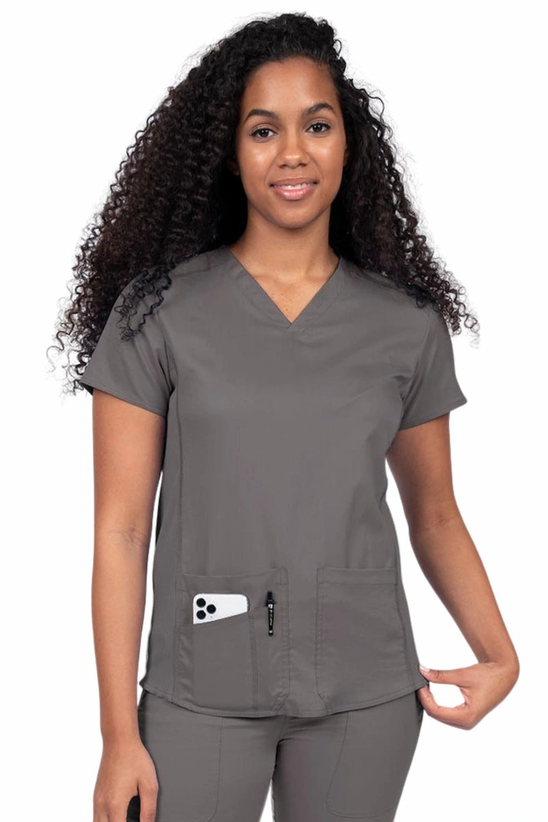 Nurse wearing an Epic by MedWorks Women's Blessed Scrub Top in pewter with a V-neckline & short sleeves.