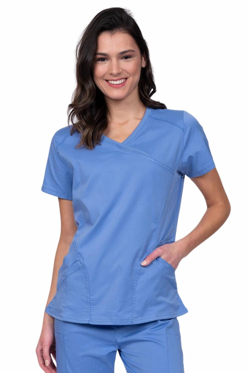 Young RN wearing an Epic by MedWorks Women's Knit Collar Mock Wrap Scrub Top in ceil featuring a Y-neckline with short sleeves.