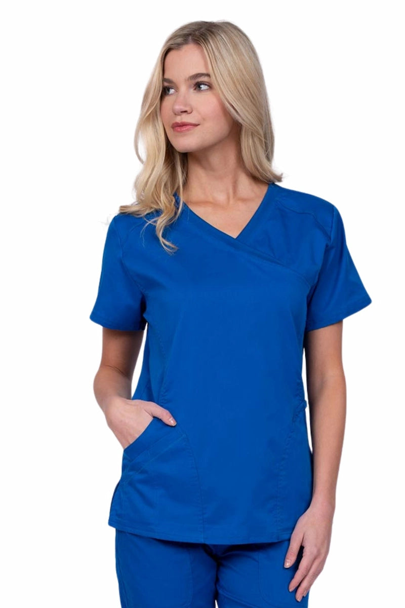 Young RN wearing an Epic by MedWorks Women's Knit Collar Mock Wrap Scrub Top in royal featuring a Y-neckline with short sleeves.