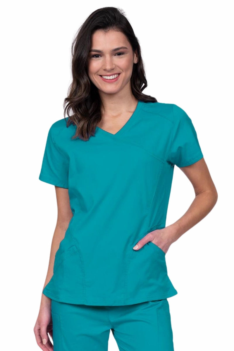 Young RN wearing an Epic by MedWorks Women's Knit Collar Mock Wrap Scrub Top in teal featuring a Y-neckline with short sleeves.