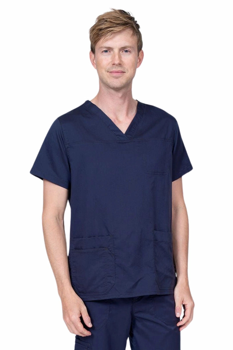 Male healthcare professional wearing an Epic by MedWorks Men's Scrub Top in navy with 2 front patch pockets and 1 exterior cell phone pocket on the wearer's right side.