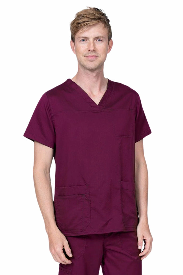 Male healthcare professional wearing an Epic by MedWorks Men's Scrub Top in wine with 2 front patch pockets and 1 exterior cell phone pocket on the wearer's right side.