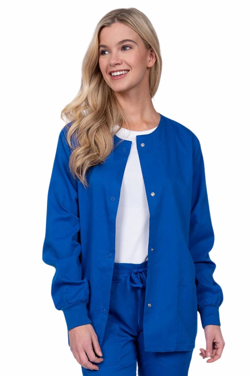 Young female healthcare worker wearing an Epic by MedWorks Women's Snap Front Scrub Jacket in royal with two front patch pockets.