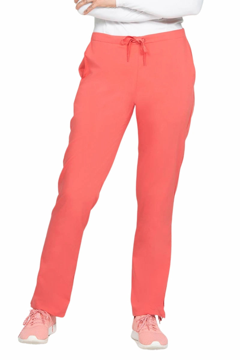 A young female Nurse wearing an Epic by MedWorks Women's Natural Rise Flare Leg Scrub Pant in Coral size XS featuring a drawstring waist with back elastic.