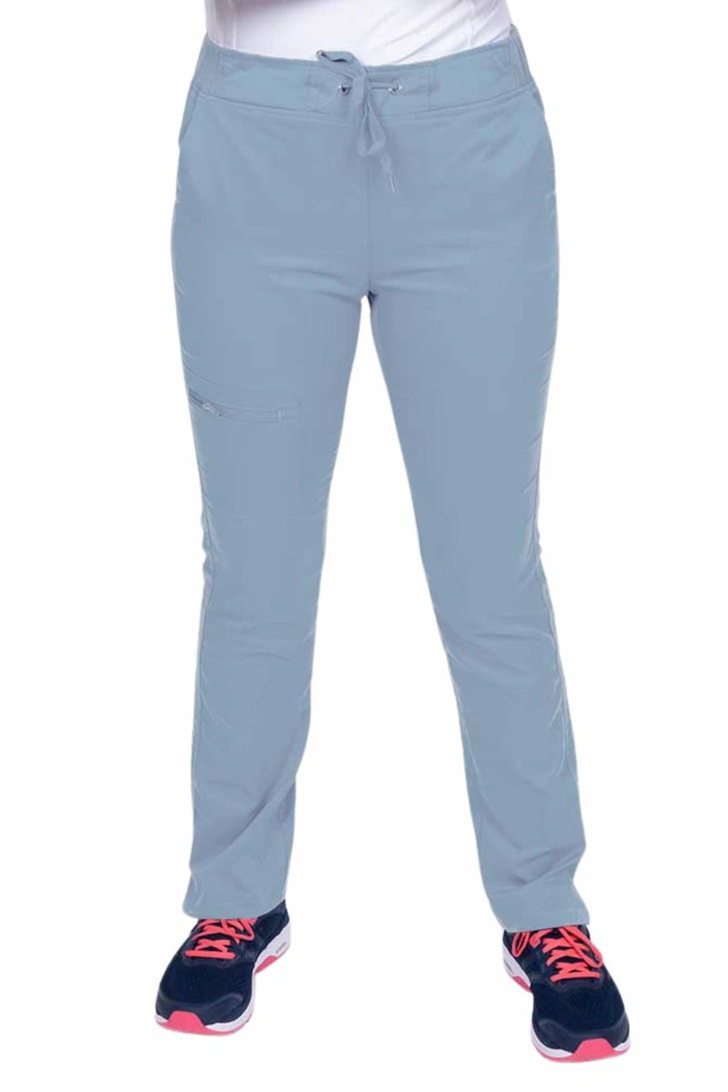 Young healthcare worker wearing an Epic by MedWorks Women's Blessed Skinny Yoga Scrub Pant in blue fog featuring side slits for additional range of motion.