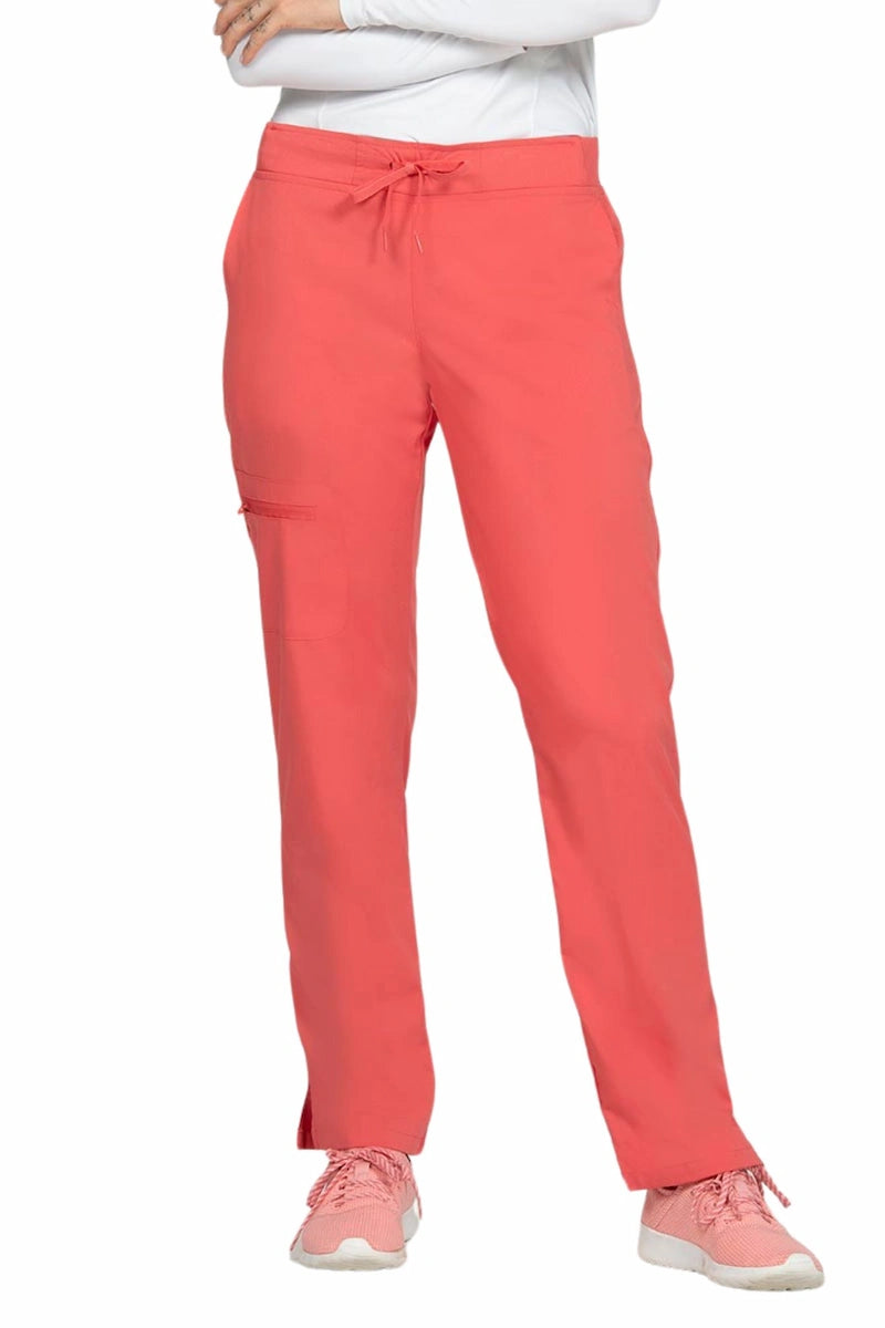 A young female Phlebotomist wearing an Epic by MedWorks Women's Skinny Yoga Scrub Pant in Coral size 3XL featuring a knit waistband.