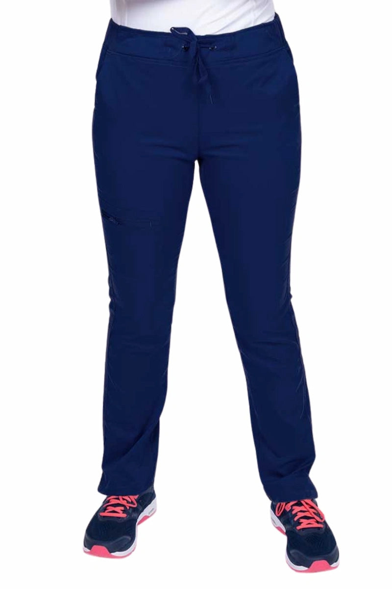 Young healthcare worker wearing an Epic by MedWorks Women's Blessed Skinny Yoga Scrub Pant in navy featuring side slits for additional range of motion.