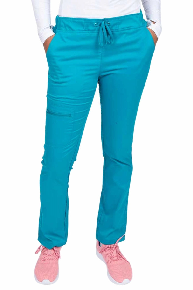 Young healthcare worker wearing an Epic by MedWorks Women's Blessed Skinny Yoga Scrub Pant in teal featuring side slits for additional range of motion.