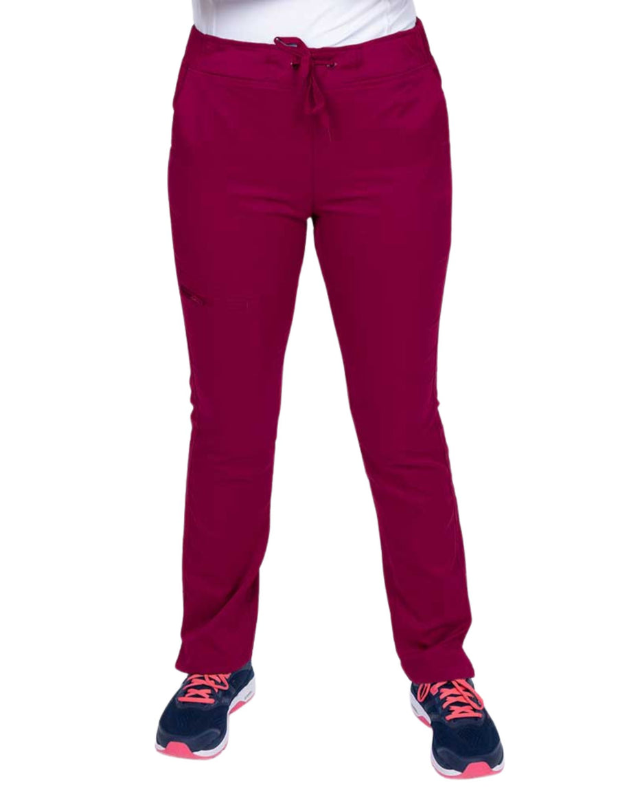 Young healthcare worker wearing an Epic by MedWorks Women's Blessed Skinny Yoga Scrub Pant in wine featuring side slits for additional range of motion.