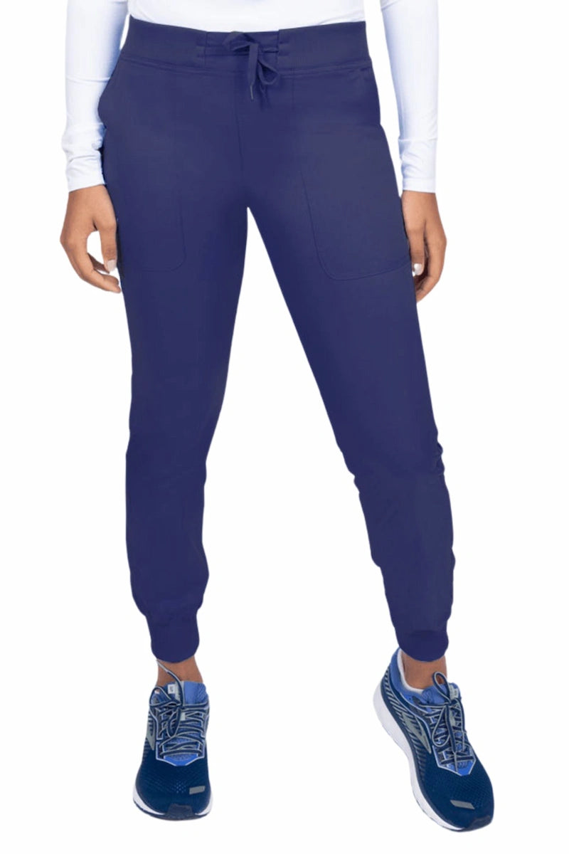 A young female Phlebotomist wearing an Epic by MedWorks Women's Yoga Jogger Scrub Pant in Navy size 3XL featuring a contemporary fit.