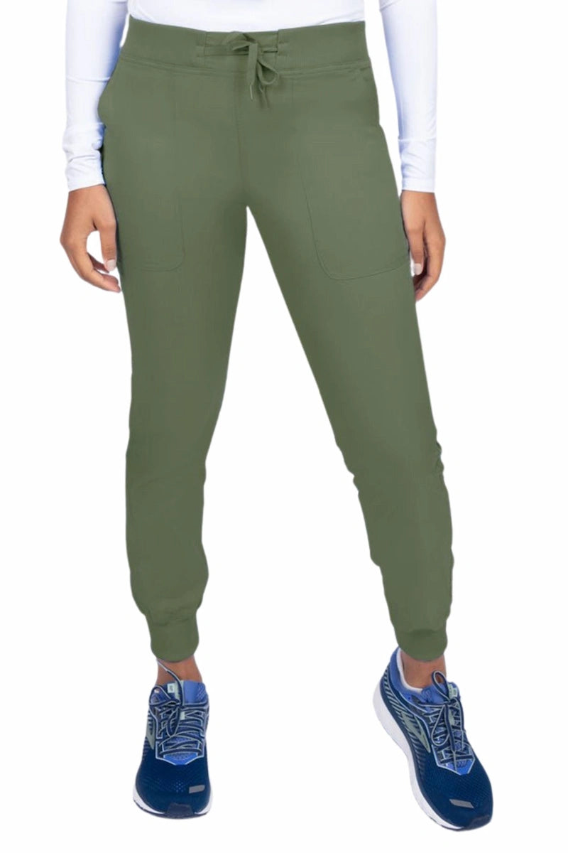 A young female Phlebotomist wearing an Epic by MedWorks Women's Yoga Jogger Scrub Pant in Olive size 3XL featuring a contemporary fit.