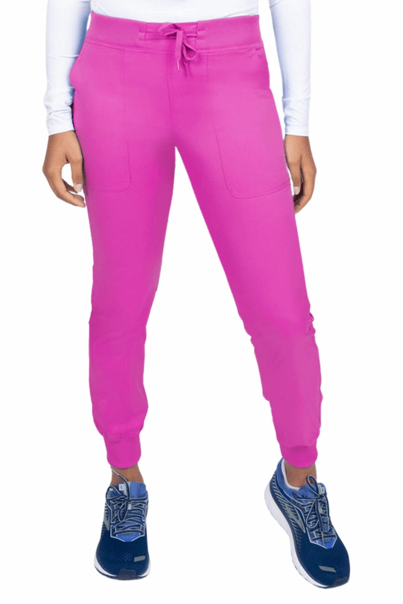 A young female Phlebotomist wearing an Epic by MedWorks Women's Yoga Jogger Scrub Pant in Shocking Pink size 3XL featuring a contemporary fit.