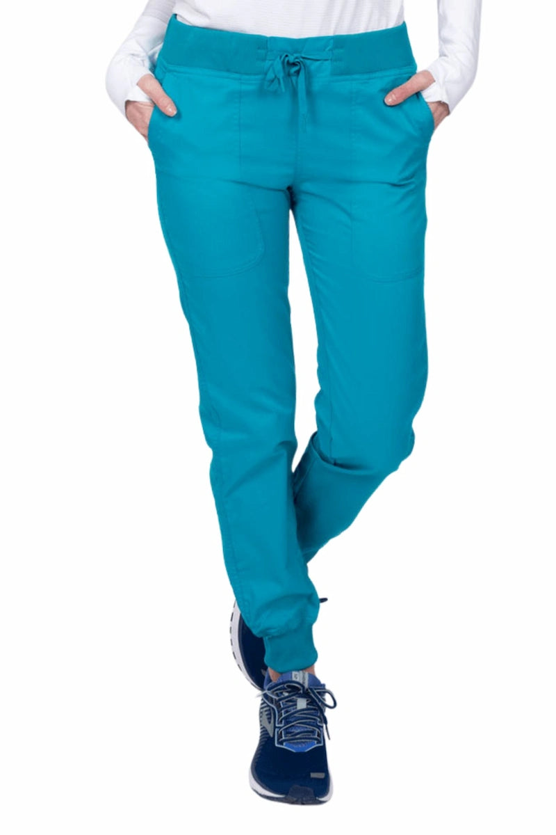 A young female Phlebotomist wearing an Epic by MedWorks Women's Yoga Jogger Scrub Pant in Teal size 3XL featuring a contemporary fit.