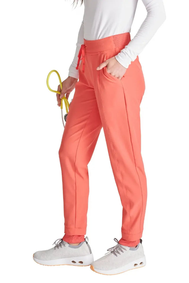 The Allura Women's High Gusset Scrub Jogger in Cayenne featuring two roomy front angled pockets.