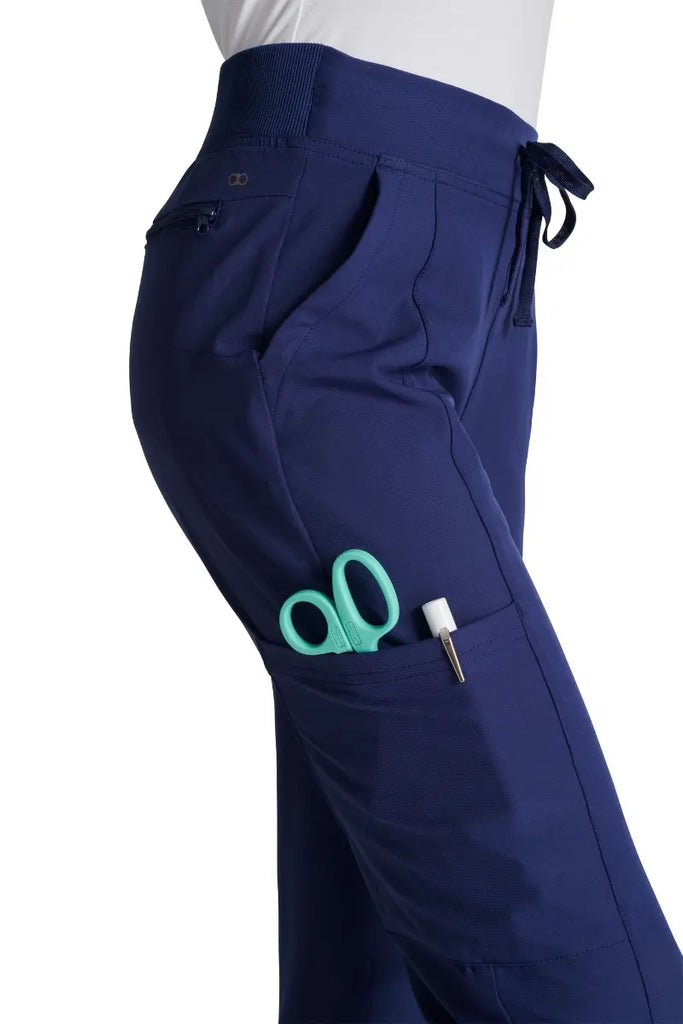 A close look at the secure cargo pocket with a security ring clasp and bungee cord on the Allura Women's High Waist Gusset Jogger in Navy size Small Petite.