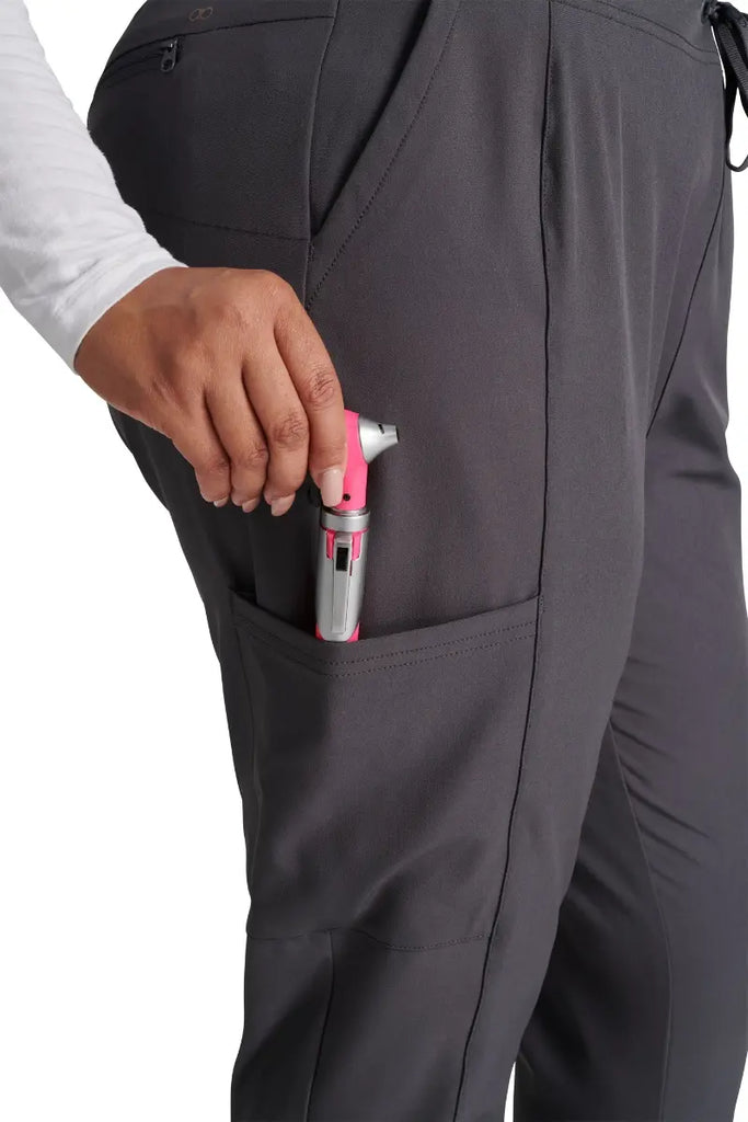 A close look at the secure cargo pocket with a security ring clasp and bungee cord on the Allura Women's High Waist Gusset Jogger in Pewter size Small Petite.
