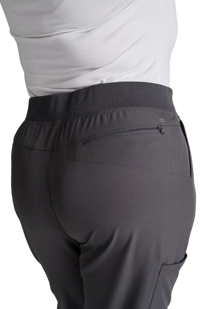 A close look at the back in-seam security zip pocket on the Allura Women's High Waist Gusset Scrub Jogger in Pewter.