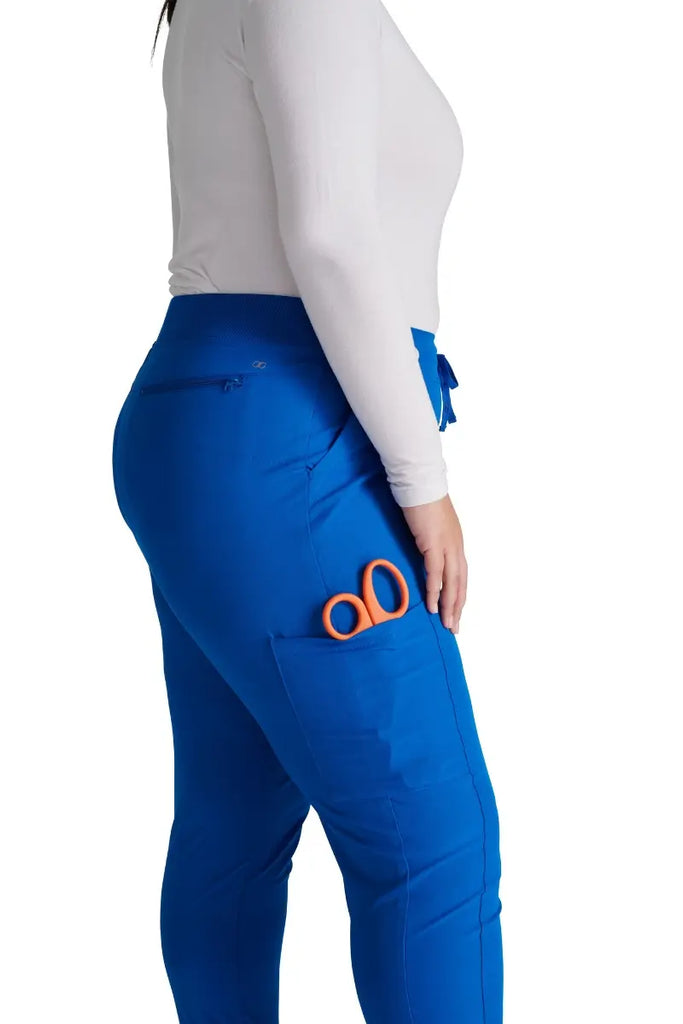 A close look at the secure cargo pocket with a security ring clasp and bungee cord on the Allura Women's High Waist Gusset Jogger in Royal size Small Petite.