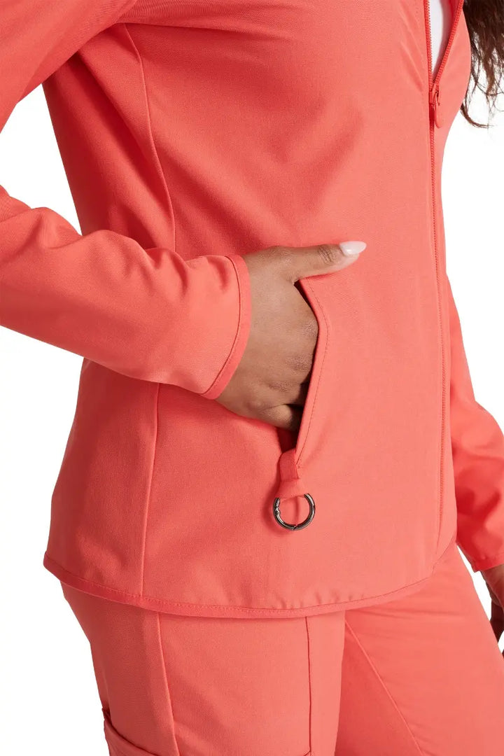 A close look at the front welt pockets on the Allura Women's Zip-Up Scrub Jacket in Cayenne.