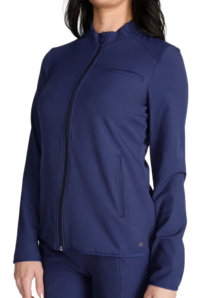 A close look at the front welt pockets on the Allura Women's Zip-Up Scrub Jacket in Navy.