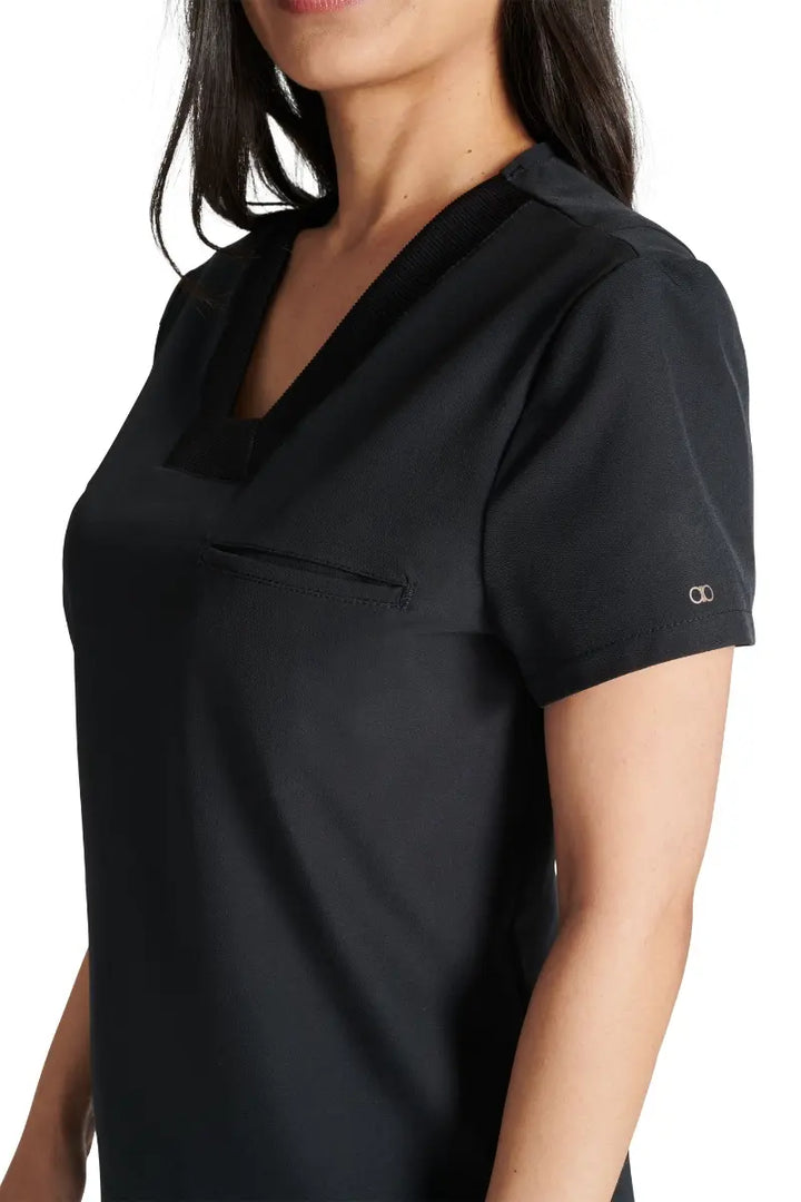 A close look at the mitered neckline and rib knit trim on the Allura Women's V-neck Scrub Top in Black.