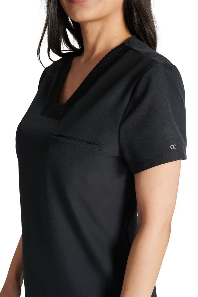 A close look at the mitered neckline and rib knit trim on the Allura Women's V-neck Scrub Top in Black.