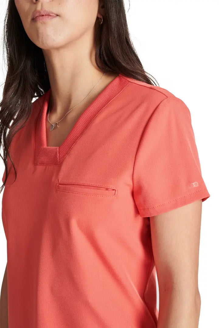 A close look at the mitered neckline and rib knit trim on the Allura Women's V-neck Scrub Top in Cayenne.