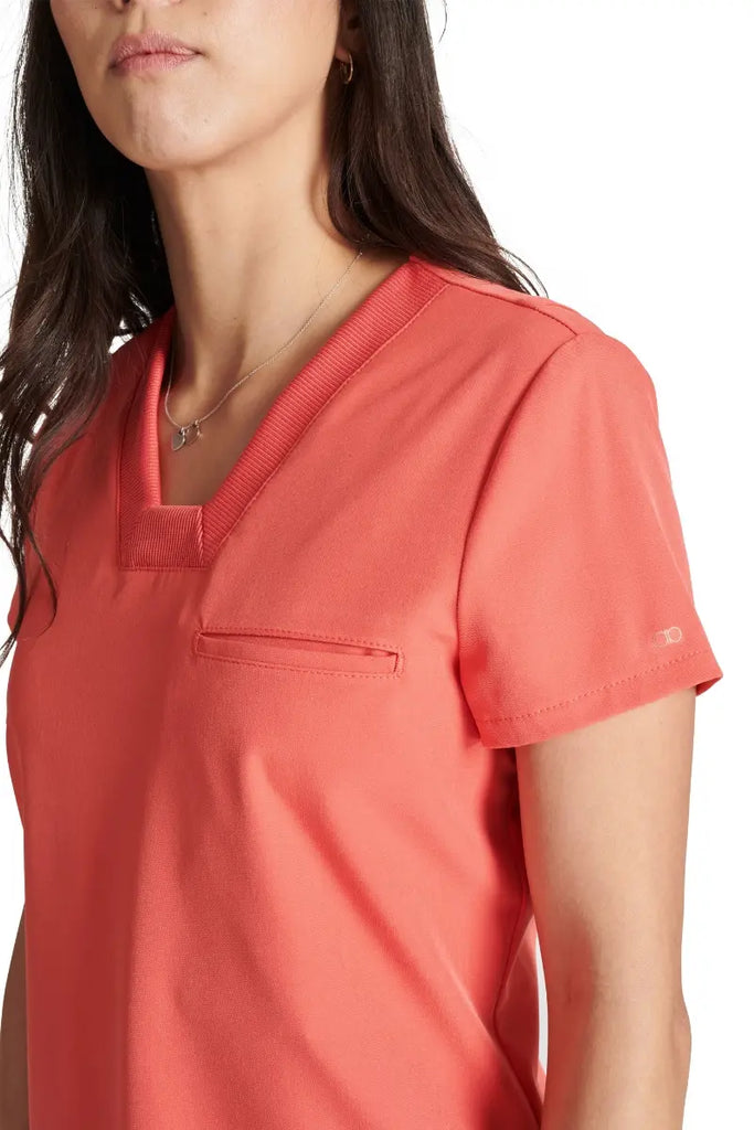 A close look at the mitered neckline and rib knit trim on the Allura Women's V-neck Scrub Top in Cayenne.