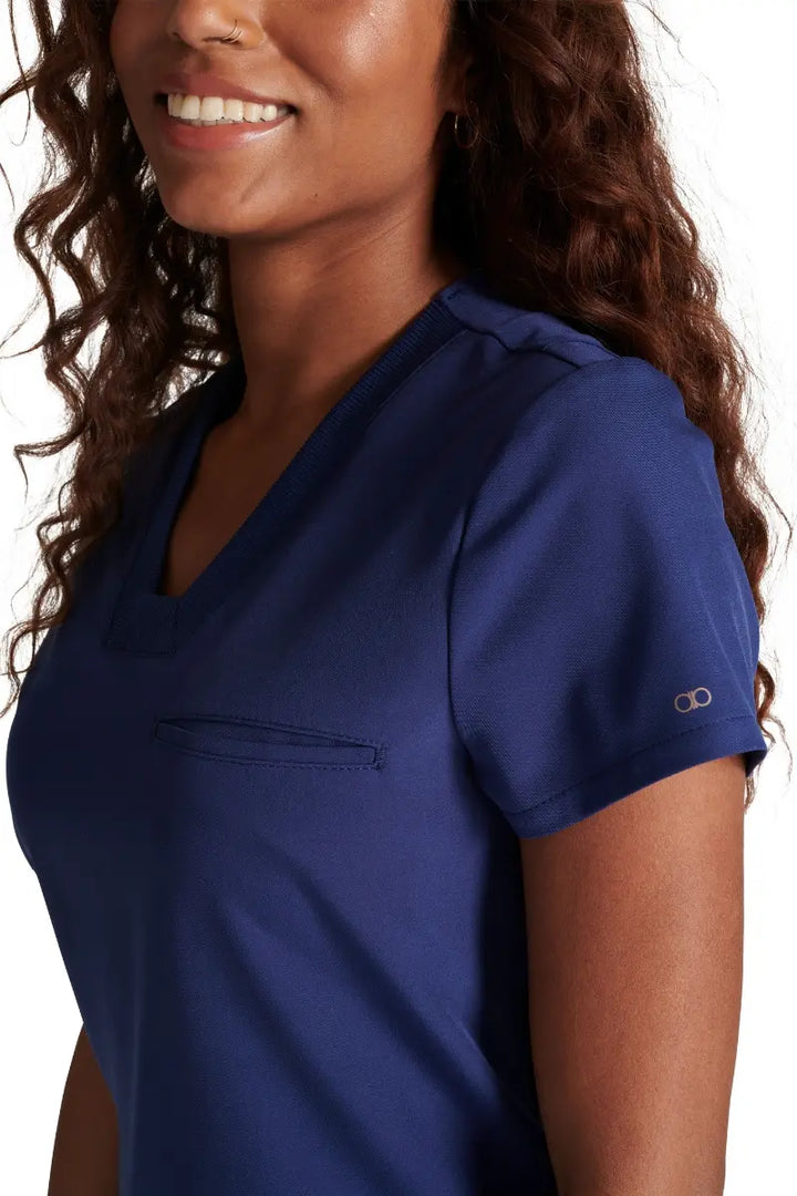 A close look at the mitered neckline and rib knit trim on the Allura Women's V-neck Scrub Top in Navy.