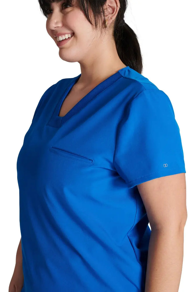 A close look at the mitered neckline and rib knit trim on the Allura Women's V-neck Scrub Top in Royal Blue.