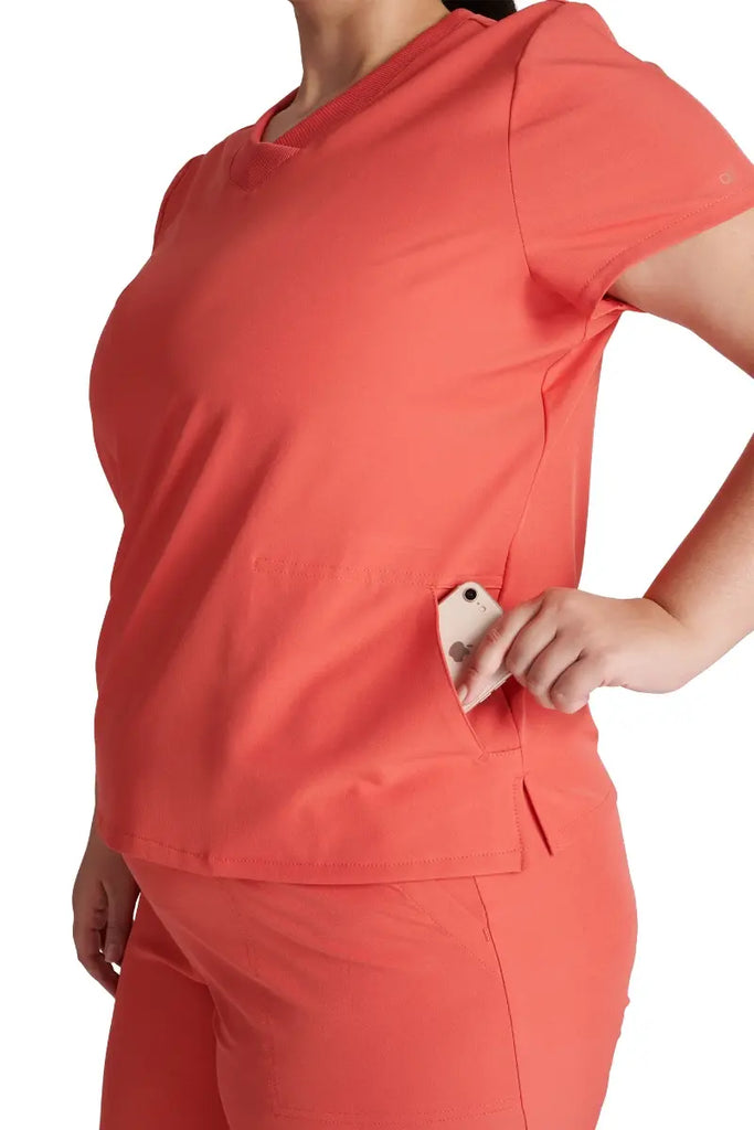 A close look at the left side pocket of the Allura Women's Stylized V-neck in Cayenne size 3XL.