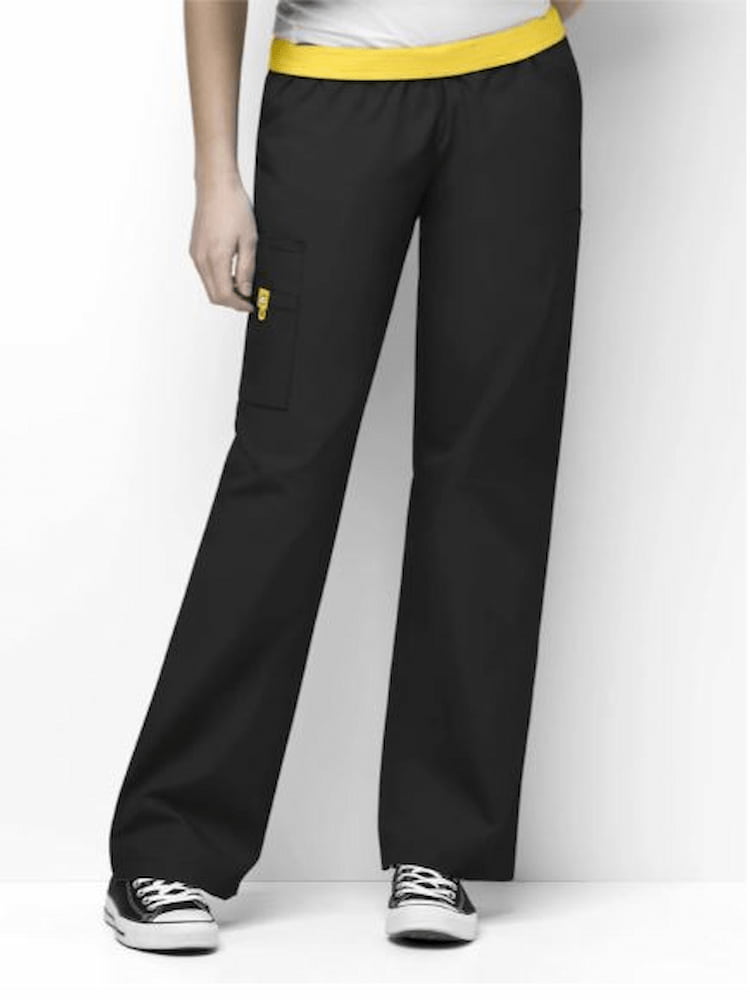 A middle aged female family practitioner wearing a pair of WonderWink Women's Elastic Waist Quebec Scrub Pants in Black size 4XL featuring a fully elastic waistband that can be folded down.