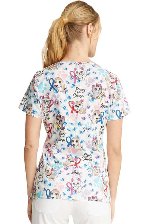 A female LPN wearing a Cherokee Women's V-Neck Print Scrub Top in "Paws for a Cause" featuring a center back length of 26.5".