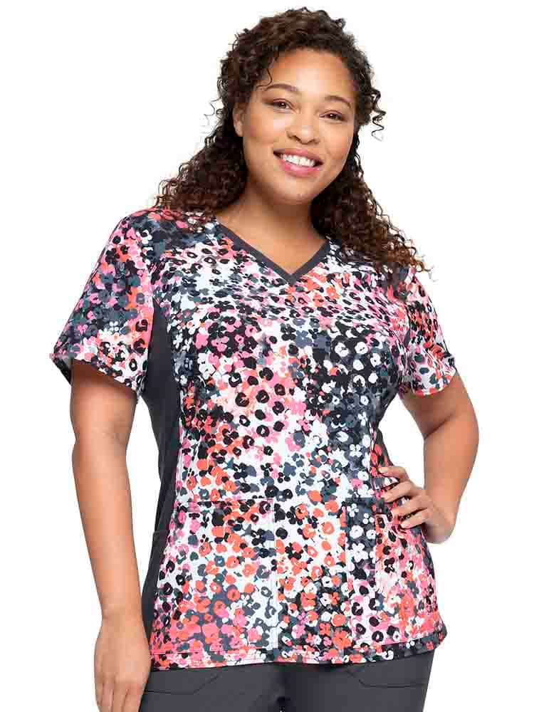 Young woman wearing a Cherokee Infinity Women's V-Neck Knit Panel Top in Blooming Cheetah featuring a unique fabric made of 52% recycled polyester.