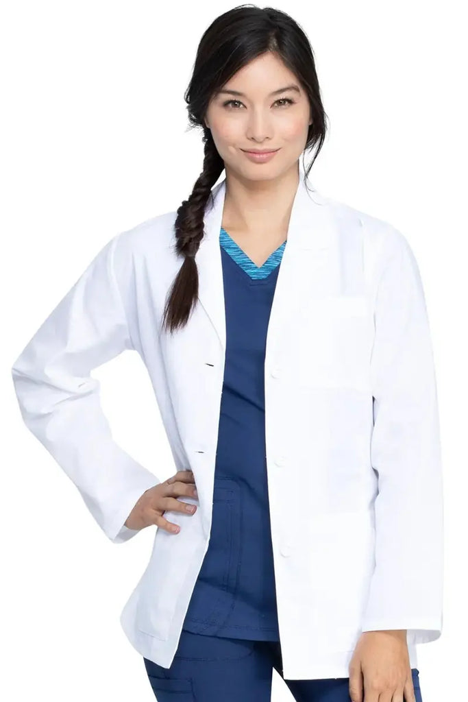 A young female Physician wearing a Dickies Women's 28" EDS Signature Lab Coat in White featuring a three button closure.